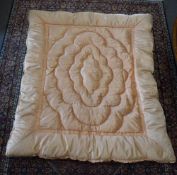 A 20th century silk eiderdown in blush pink peach shade, with scalloped diamond central quilting