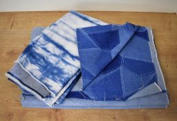 Two lengths of patterned denim, the first having a printed geometric patchwork design, measures