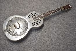 A traditional resonator steel guitar, possibly by Johnson, serial number stamped to top of headstock