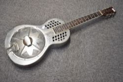 A traditional resonator steel guitar, possibly by Johnson, serial number stamped to top of headstock