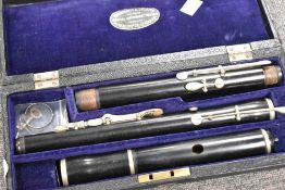 An antique woodwind eight button flute, believed to be Rushworth and Dreaper, in fitted case