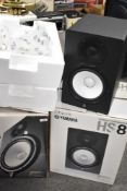 A pair of Yamaha HS8 powered studio monitors, boxed