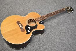 A Gibson electro acoustic guitar, model J-180 EC, with impressed serial numbers to headstock and