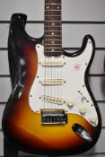 An unbranded stratocaster style electric guitar