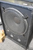 A large speaker cabinet , in peavey cabinet, on castors, speaker unidentified, possibly 15inch