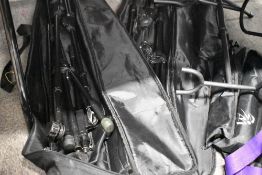A selection of various stands including two travel bags of mic stands, and other assorted music