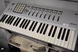 A Korg Kontrol 49 midi studio controller, used, with box (no software)