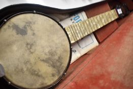 An early to mid 20th Century John Grey & Sons banjo ukulele , having pearlescent neck and metal