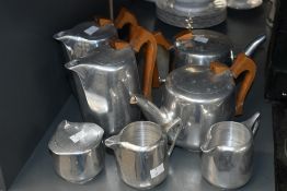A mid 20th-century Picquot aluminium tea and coffee set, featuring teak wood handless and a stylised
