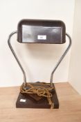 A early 20th-century Art Deco bakelite and chrome tubular desk lamp, featuring a dark bankers-