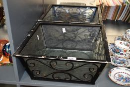 Two large 20th-century decorative metal light fittings/shades, having removable glass inserts,
