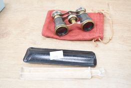 A late 19th to early 20th-century pair of brass field binoculars, featuring an intricate embossed