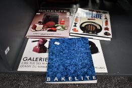 Three vintage Bakelite books and a French bakelite poster, all marked, (4), condition consistent