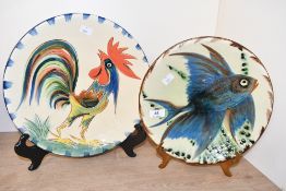 Two large mid 20th-century Spanish Puigdemont majolica glazed decorative plates, to feature a blue