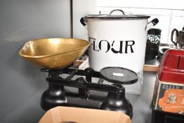 A vintage metal and brass Salter scale with iron weights; sold with a metal Flour lidded tin,