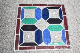 A large 20th-century stained glass window panel, featuring green, blue and clear textured glass