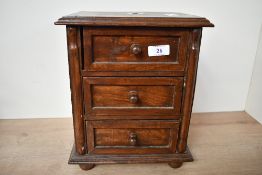 A small early 20th-century wooden tabletop drawer chest, thought to be apprentice piece, featuring