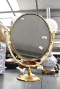 A fine large 20th-century brass oval vanity table mirror, upon a graduated circular base,