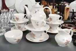 A sweet 20th-century Royal Doulton 'Tumbling Leaves' china tea set, to feature cups, saucers,