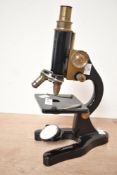 An early 20th-century Flatters and Garnet Limited of Manchester metal monocular microscope, having