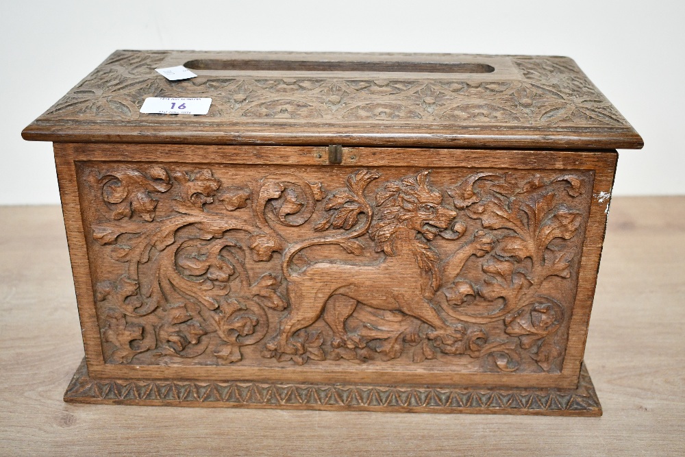 A small 20th-century carved wooden tissue box holder, in the form of a chest, featuring detailed