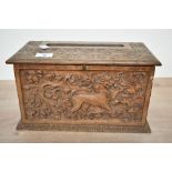 A small 20th-century carved wooden tissue box holder, in the form of a chest, featuring detailed