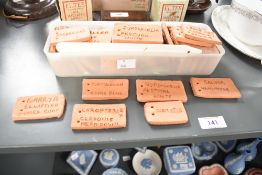 A quantity of handmade terracotta clay garden markers, for identifying garden foliage, (1 small