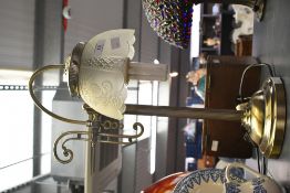 A contemporary Victorian-style metal swan neck table lamp, featuring a reeded column base and a