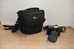 A Nikon D80 digital camera with AF S Nikkor 18-200mm 1:3,5-5,6 G ED lens having charger and