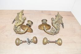 A pair of 19th-century French-style brass wall scone, featuring a winged caryatid figure with