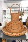 Three vintage woven baskets, to feature two larger centrepiece bowls and a wicker basket with a