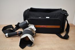A Pentax MZ30 camera with SMC Pentax FA 1:3,8-5,6 28-200mm lens in soft camera bag