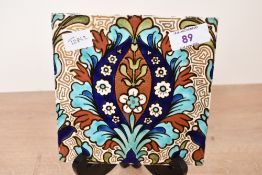 A late 19th-century to early 20th-century Arts and Crafts pottery tile in the style of William De