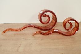 Two 20th-century Murano-style art glass sculptures, featuring abstract red and orange swirled ribbon