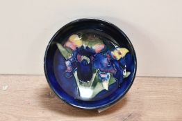 A small 20th-century Moorcroft pottery 'Orchid' pin dish, having a colourful tube-lined orchid