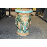 A large vintage ceramic elephant garden stool/plant stand, featuring colourful elephants decorated