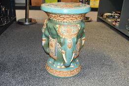A large vintage ceramic elephant garden stool/plant stand, featuring colourful elephants decorated