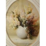 A pair of 20th Century lithographs, floral still life studies in oval form, within stepped