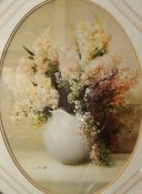 A pair of 20th Century lithographs, floral still life studies in oval form, within stepped