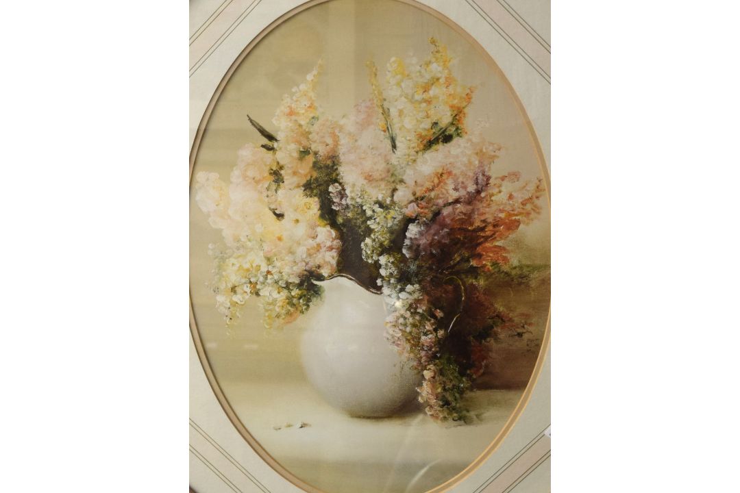 A pair of 20th Century lithographs, floral still life studies in oval form, within stepped - Image 1 of 3