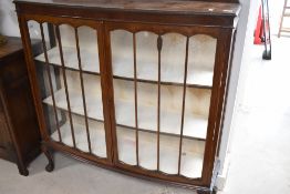 An early 20th Century oak china cabinet having ledge back and ball and claw feet, width approx.