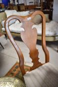 A pair of reproduction vase back dining chairs having overstuffed seats and cabriole legs