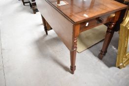 A Victorian mahogany dining table having frieze drawer and drop flaps having frieze drawer and