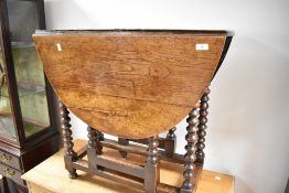 A late 19th or early 20th Century oak gateleg dining table of small proportions, with oval top,