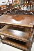 A late 19th or early 20th Century oak buffet type shelf having carved ledge back and turned