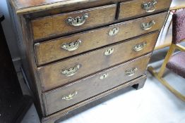A 19th Century oak chest of two over three drawers in the Georgian style , having brass drop handles