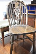 A set of six traditional dark stained wheel back dining chairs