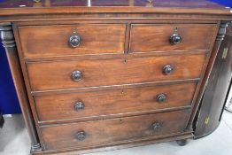 A Victorian mahogany chest of two short over three long drawers, with column supports , turned