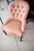 A modern nursing chair having classical rose pink upholstery