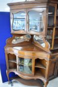 A late Victorian or Edwardian mahogany corner display having Greek key style cornice, over glazed